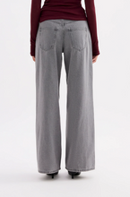 A back view shows the Steel boyfriend jeans with rear patch pockets and a relaxed wide-leg fit.

