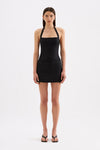 A model wears a black halter top with a straight neckline and fitted silhouette in a full front studio view.