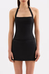 Close-up front view of the black halter top showing the straight neckline, fitted shape and wide halter straps.