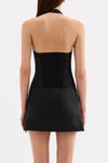 Back view of the black halter top showing the adjustable neck strap and shirring panel.