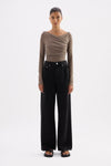 Truffle long sleeve top styled with black wide-leg jeans in a full-length front view.