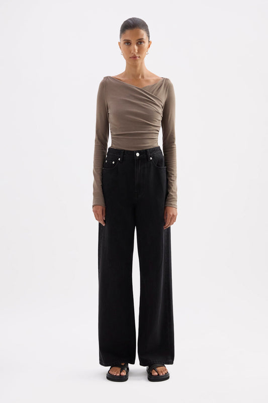 Truffle long sleeve top styled with black wide-leg jeans in a full-length front view.