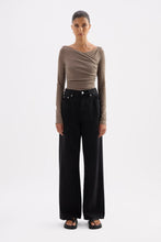 Truffle long sleeve top styled with black wide-leg jeans in a full-length front view.