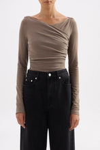 Close front view of the fitted truffle top showing the softly draped neckline and gathered waist.