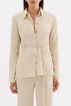 Close-up front view highlighting the traditional collar, shell buttons and gathered waist tie.