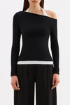 Front close-up showing the fitted ribbed silhouette, long sleeves and asymmetric neckline with white contrast detail.