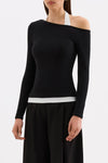 Three-quarter front view highlighting the one-shoulder effect and fitted shape of the black long sleeve top.