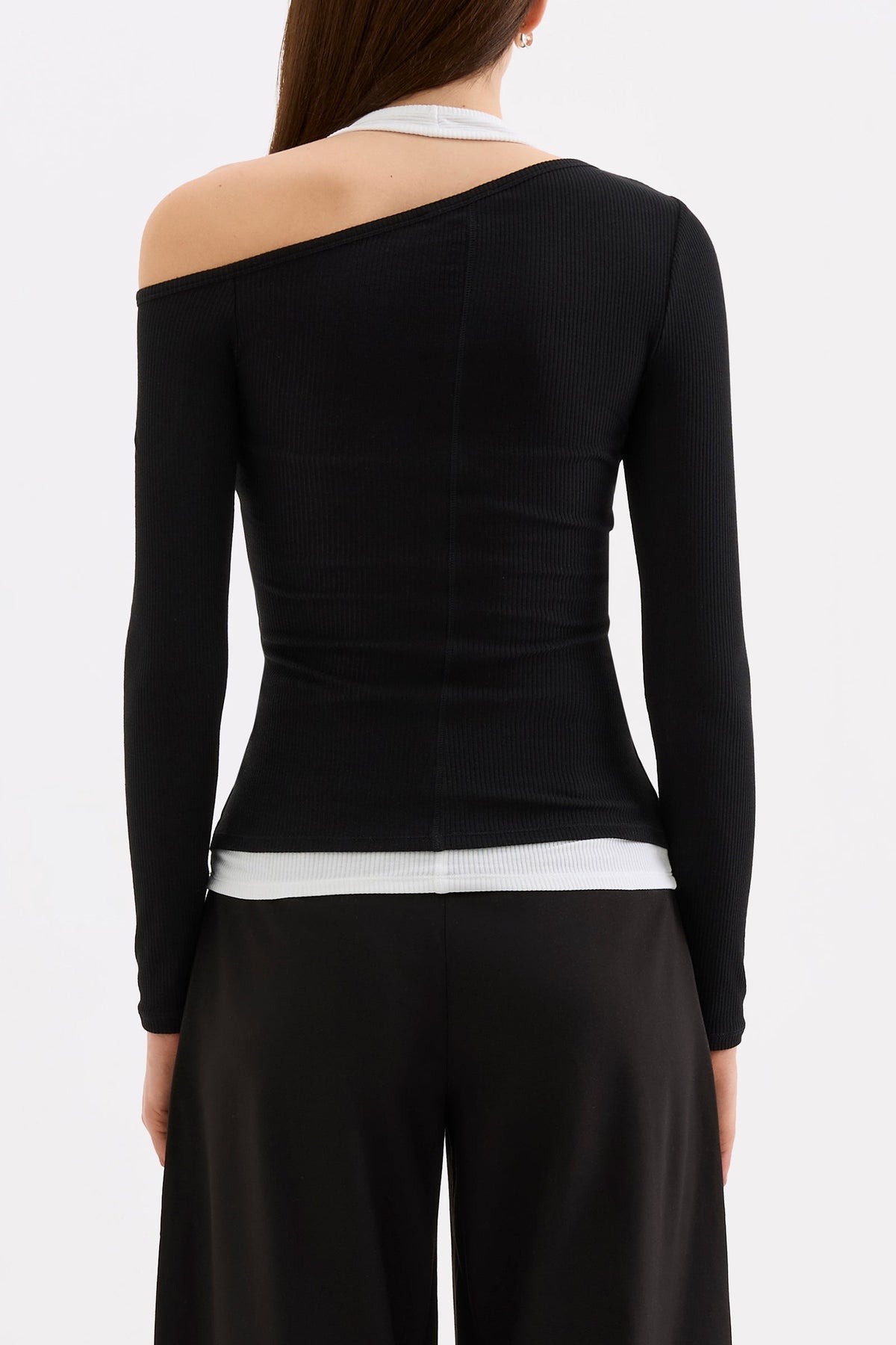 Back view showing the asymmetrical neckline, fitted long sleeves and white contrast layer at the hem.