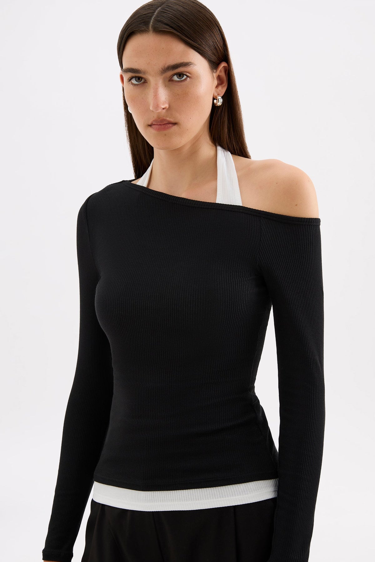 Close-up angled front view highlighting the asymmetrical shoulder line and slim ribbed fit.