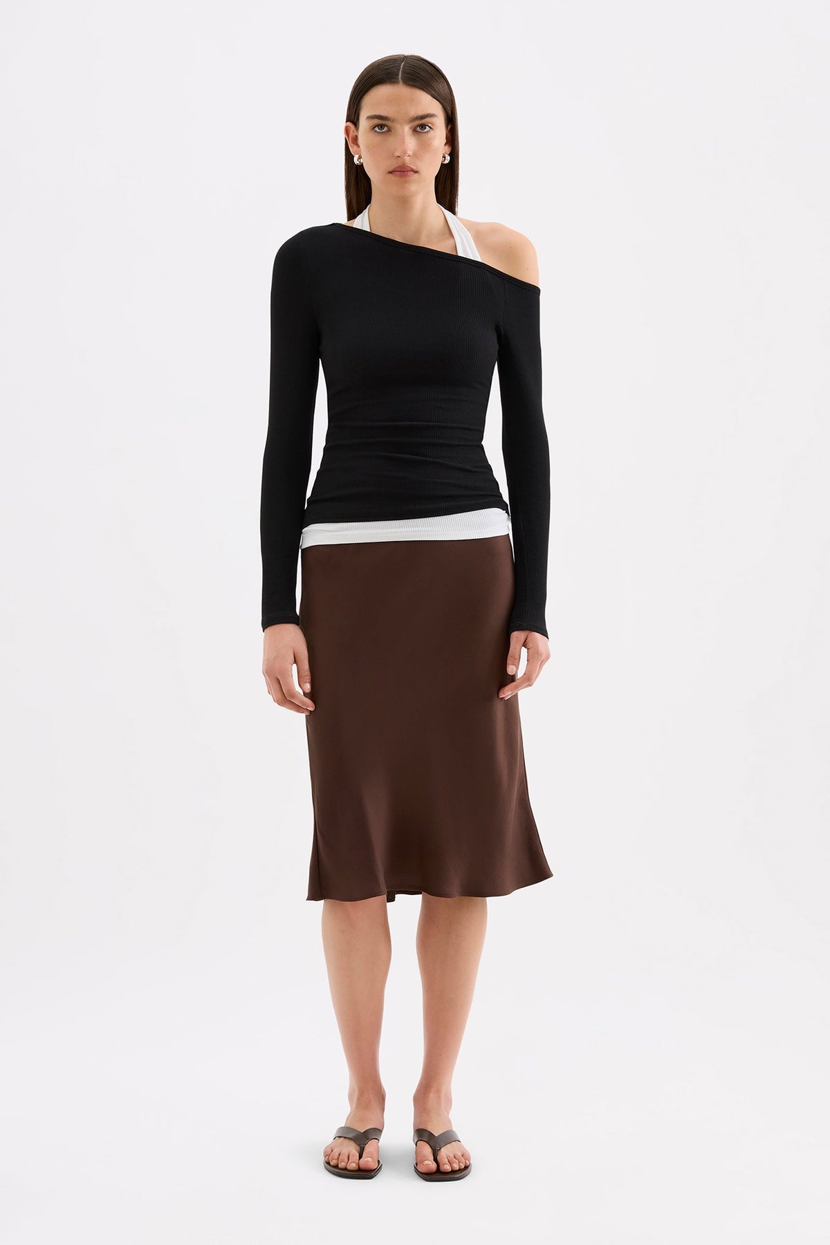 Full-length front view styled with a brown midi skirt, showing the fitted hip-length silhouette.