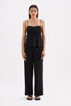 A model wears a black cami top with thin adjustable straps and wide side panels in a full front studio view.