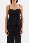 Close-up front view of the black cami top showing the thin straps, straight neckline and flowing side panels.