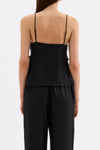 Back view of the black cami top showing the thin adjustable straps and straight back neckline.