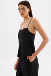 Side view of the black cami top showing the wide side split and tie-up detail.
