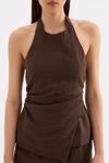 Close-up front view showing the high neckline, sleeveless cut and gathered detailing through the waist.