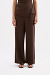 Front view highlighting the high-rise waist and relaxed full-length wide-leg silhouette.
