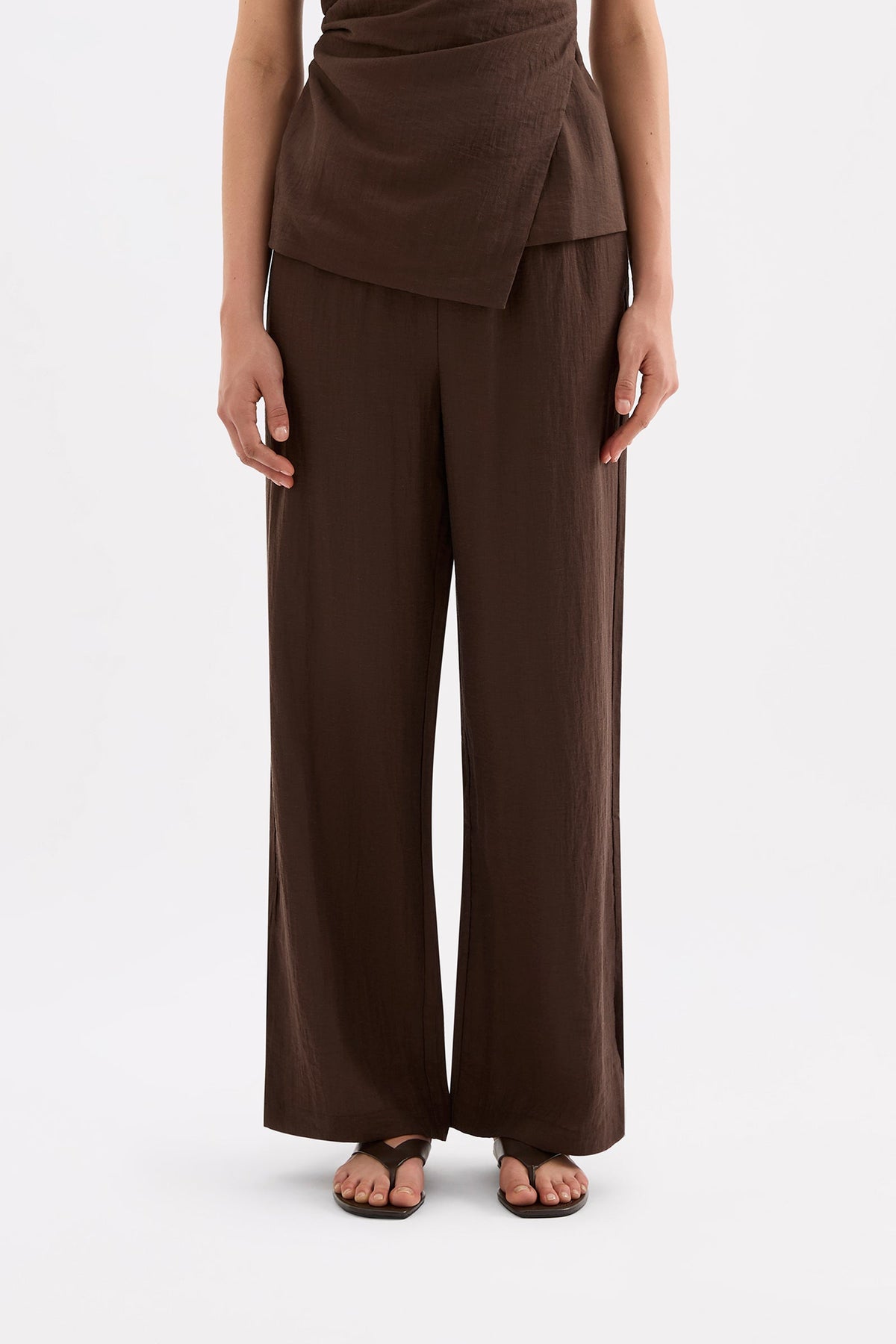 Front view highlighting the high-rise waist and relaxed full-length wide-leg silhouette.