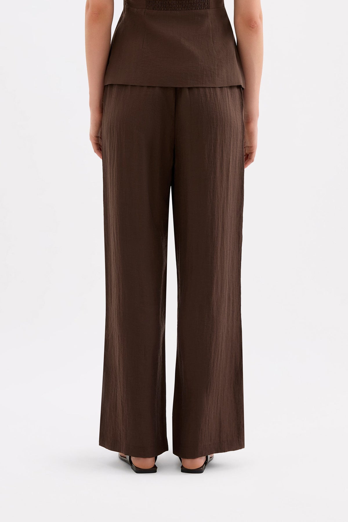 Back view of the full-length chocolate pants showing the straight relaxed drape.