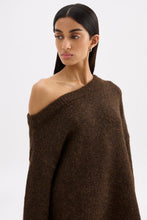 Close portrait view of the chocolate knit featuring the asymmetrical neckline and soft fluffy texture.