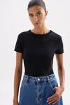 Upper-body front view highlighting the smooth fitted shape and classic crew neckline of the black tee.