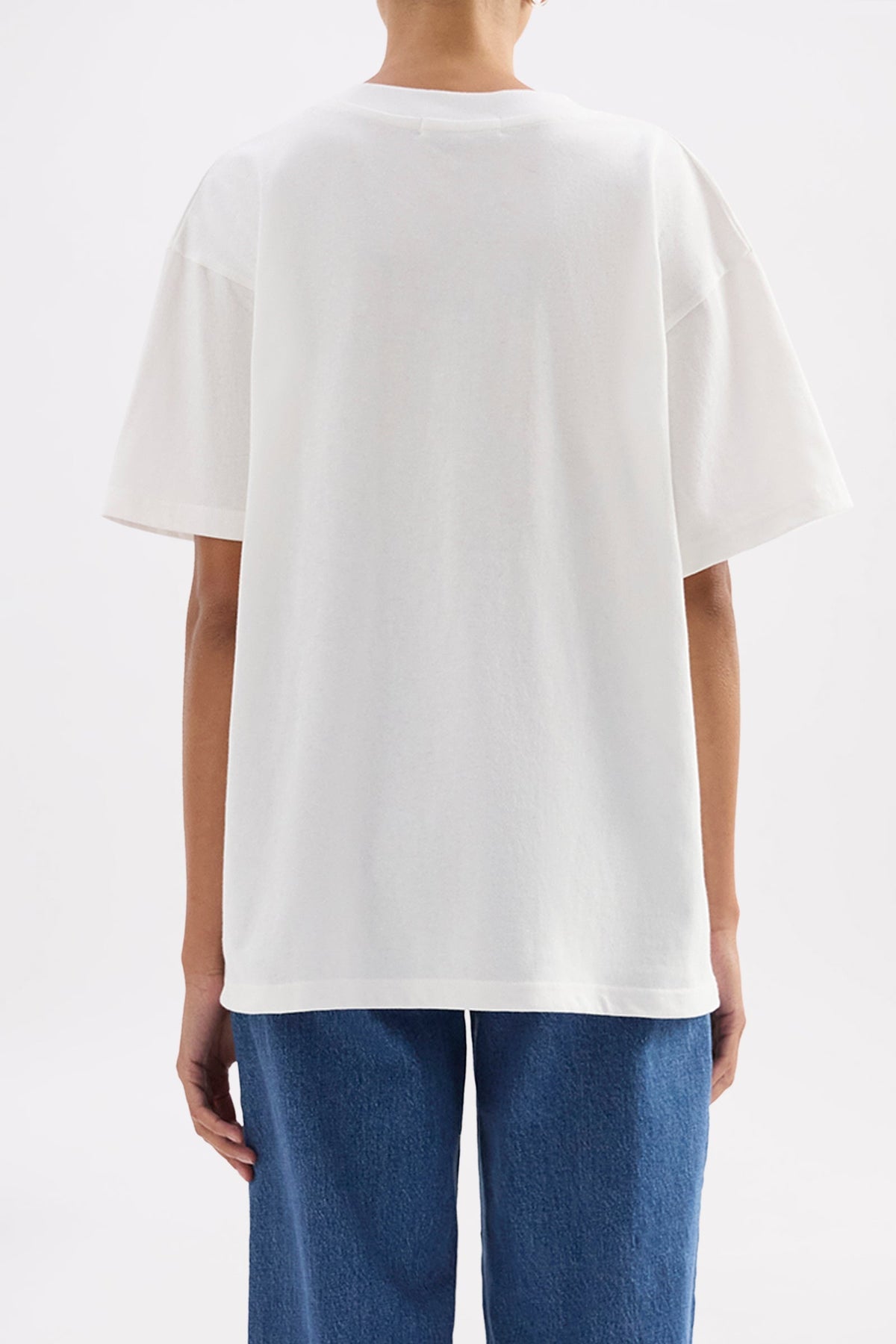 Back view of the oversized white short sleeve tee showing its relaxed straight silhouette.