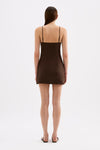 Back view of the chocolate brown mini dress showing the thin adjustable straps, fitted upper section and short skirt.