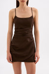 Close-up front view of the chocolate brown mini dress showing the scoop neckline, thin straps and draped detailing across the waist.