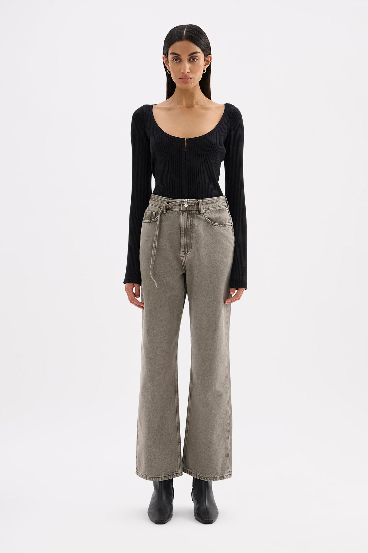 Model wearing stone grey high-rise jeans with a fitted black long sleeve top and black ankle boots in a full-length front view.