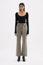 Model wearing stone grey high-rise jeans with a fitted black long sleeve top and black ankle boots in a full-length front view.