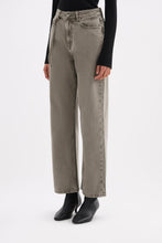 Three-quarter view showing the relaxed straight-leg shape and stone-washed grey denim finish.