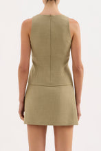 A back view shows the fitted Nude Lucy Thea Top in moss with its high back and invisible zip closure.
