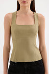 A close-up front view shows the moss Thea Top styled with black jeans, highlighting the square neckline and fitted waist.
