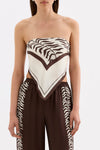 Close-up front view of the Vela print scarf styled as a strapless top, showing the brown and cream pattern and pointed centre.