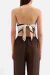 Back view of the scarf worn as a strapless top, showing the tied ends and open back.