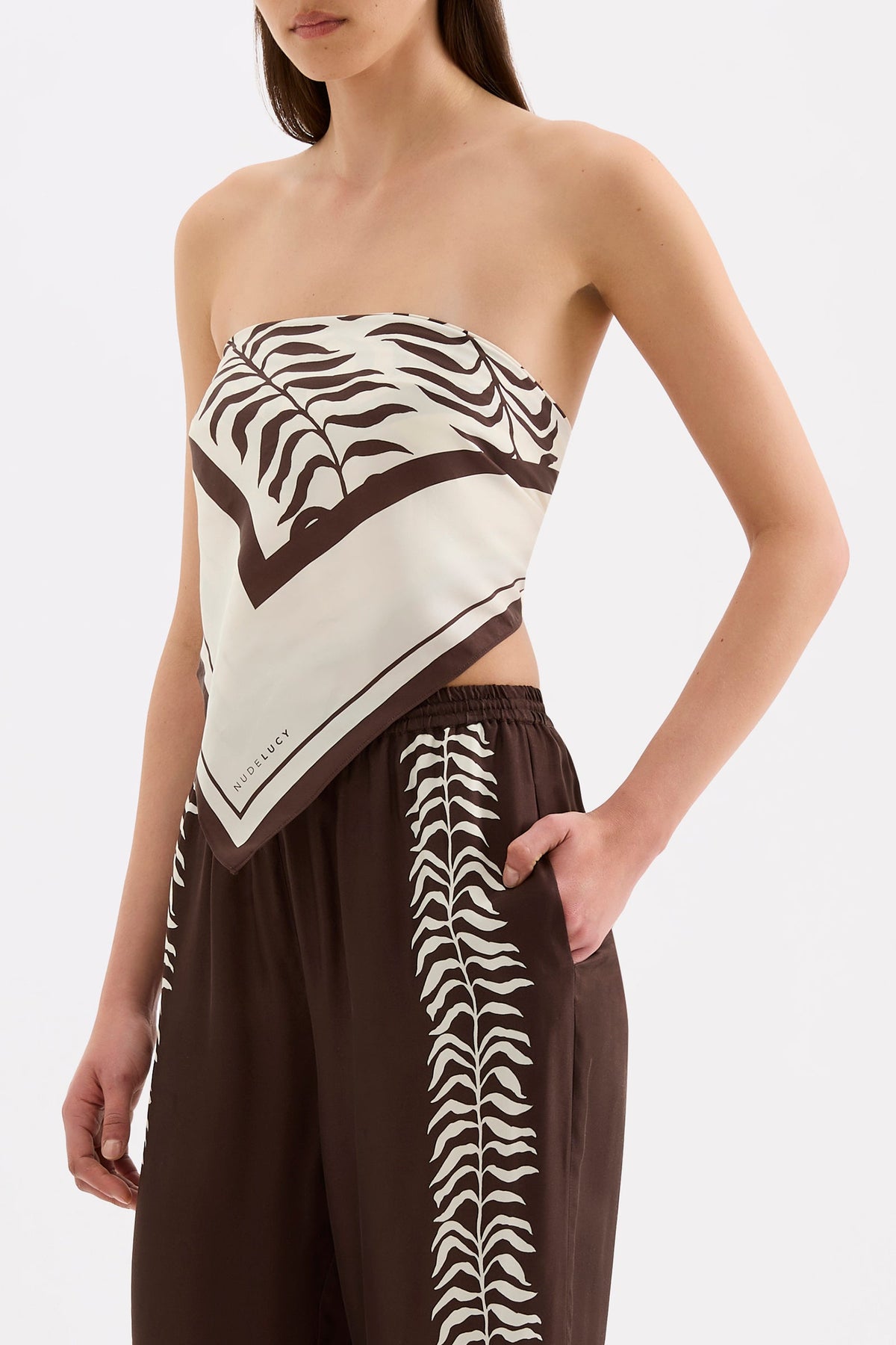 Side view of the Vela print scarf styled as a strapless top, showing the pointed front and draped fabric.