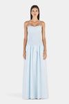 A front view of the maxi dress featuring a softly curved neckline, thin halter straps, fitted shirred bodice and gathered skirt.
