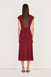 Model wearing the crimson top with the matching midi skirt, showing the fitted back, cap sleeves, cropped hem and lightweight crinkled texture in a full-length back view.