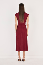 Model wearing the crimson top with the matching midi skirt, showing the fitted back, cap sleeves, cropped hem and lightweight crinkled texture in a full-length back view.