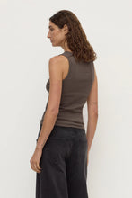Model wearing the bark rib tank with washed black jeans, showing the fitted shape, sleeveless cut and clean scoop-back silhouette, back angled view
