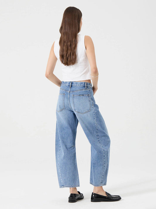 Model wearing the Rolla's Arc Barrel Jean in Lennon Vintage, showing the curved barrel-leg shape and vintage mid-blue wash, full-length back view