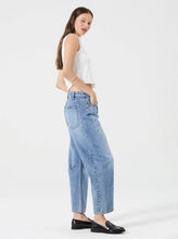 Model wearing the Rolla's Arc Barrel Jean in Lennon Vintage with a white cropped tank, showing the mid-rise fit and relaxed silhouette, full-length side view