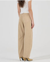 A model wears the dune barrel-leg jeans in a rear view showing the back patch pockets and relaxed fit.