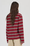 Close-up back view of the burgundy striped long-sleeve tee, showing the relaxed shoulders, horizontal stripe pattern, long sleeves and straight hem.