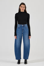 Model wearing the Rolla's Gigi Barrel Jean in Reign with a black turtleneck top, showing the super high-rise sculptural barrel-leg fit, full-length front view