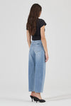 Rear view of light blue barrel jeans showing the fitted high-rise waistband, curved back yoke, signature spade-shaped back pockets with contrast stitching and relaxed legs that narrow towards the hems.