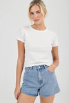 A front view of mid-blue high-rise denim shorts with a button closure, front scoop pockets and a short, slightly flared leg.