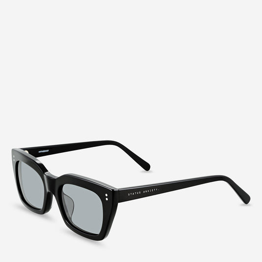 Black rectangular sunglasses shown from a front three-quarter angle with grey lenses, on a white background.