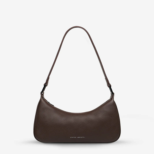Brown shoulder bag on a plain background