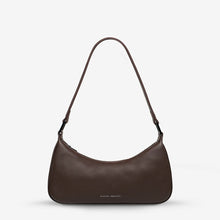 Brown shoulder bag on a plain background