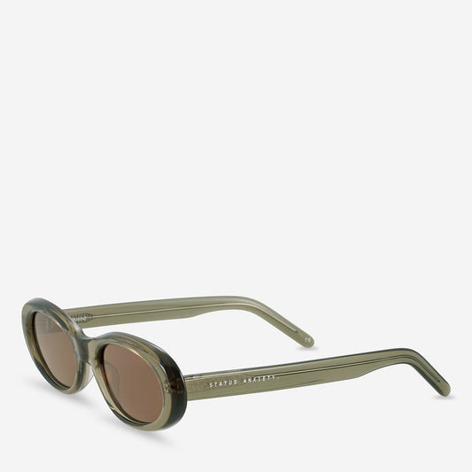 Moss oval sunglasses shown from a three-quarter front angle, highlighting the curved frame and tinted lenses.
